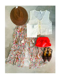 Gonna lunga con stampa paisley multicolore su fondo bianco panna, fotografata distesa insieme a cappello in paglia, top bianco, gilet in maglia, pochette rossa e décolleté